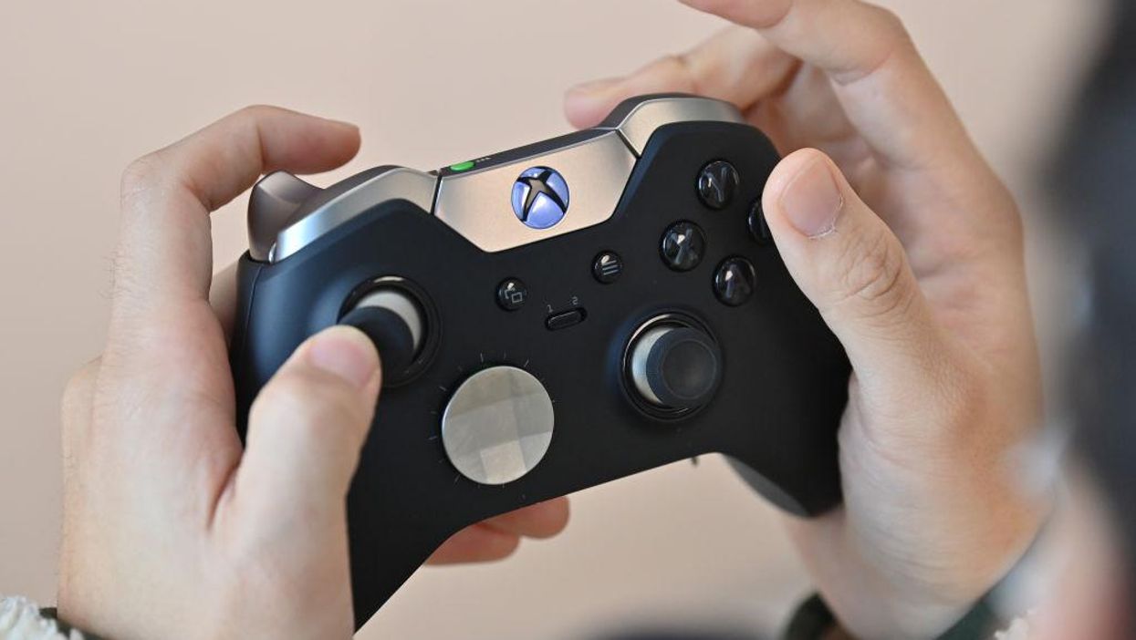 A close-up of an Xbox controller being held by a player.
