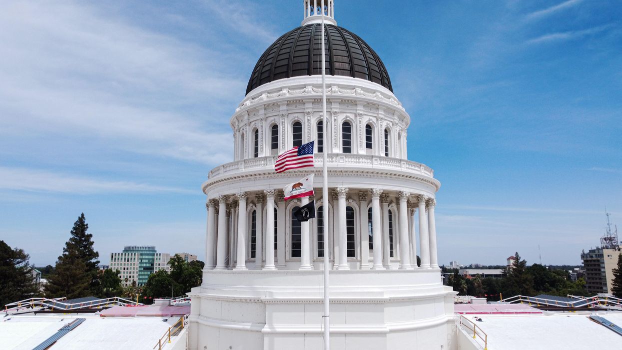 SACRAMENTO, UNITED STATES - 2022/05/27: (EDITORS NOTE: Image taken with drone) Flags of the United States and California fly at half-staff at California State Capitol Museum. President of the United States, Joe Biden ordered that all the flags of the United States be flown at half-staff through May 28. The purpose of the half-staff is to honor the victims of a mass shooting in Uvalde, Texas elementary school which happened on May 24. (Photo by Michael Ho Wai Lee/SOPA Images/LightRocket via Getty Images)